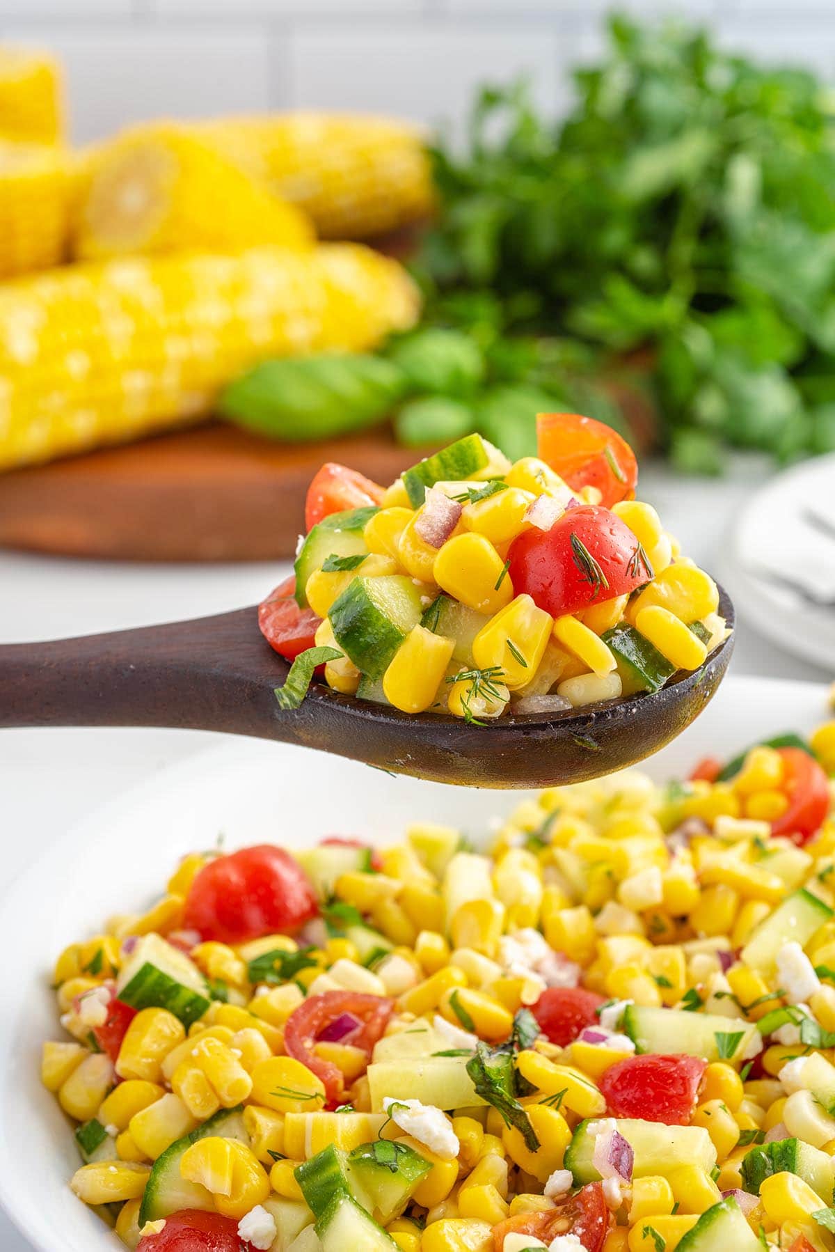corn salad in wooden spoon