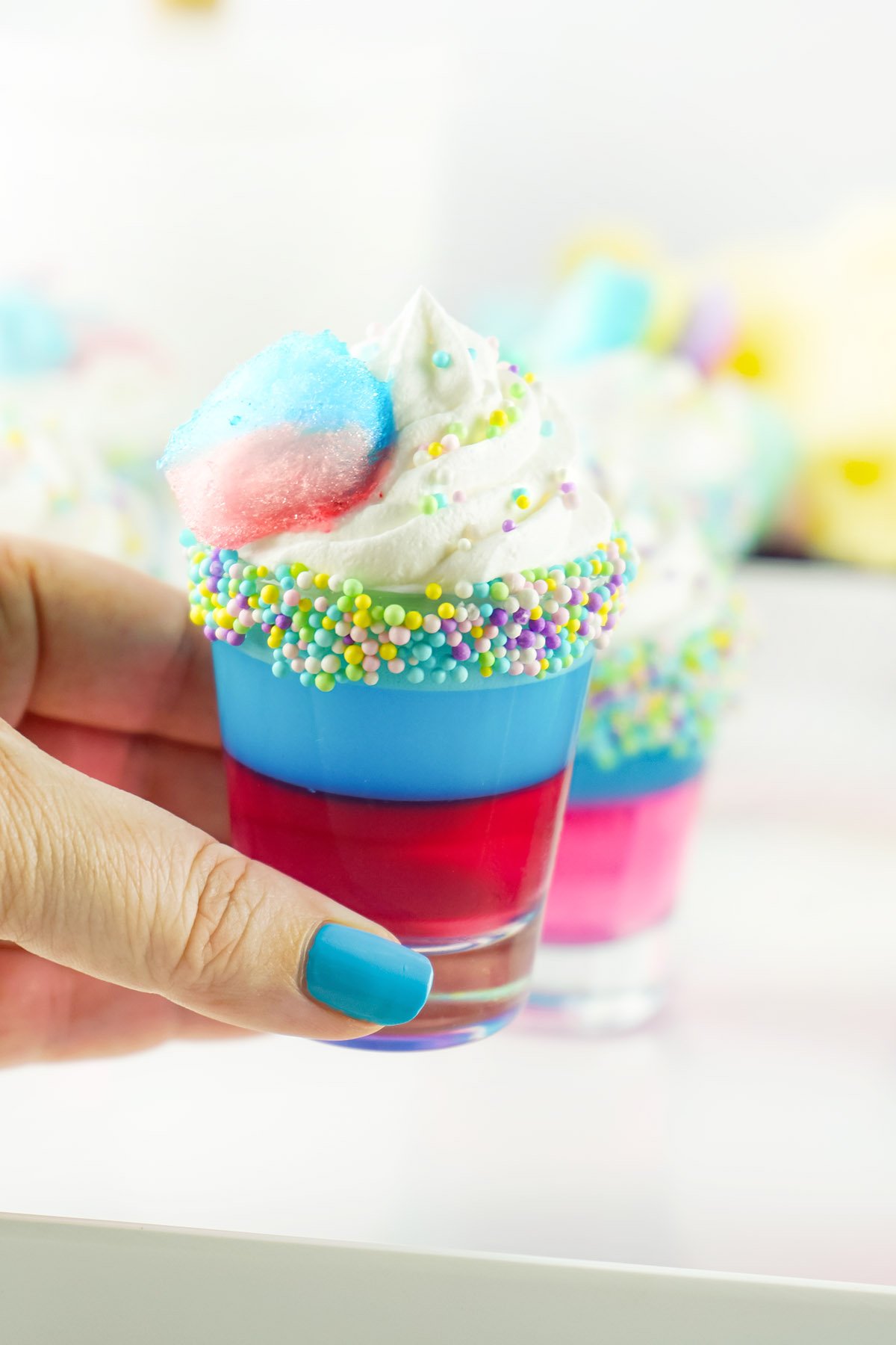 cotton candy shots held by hand
