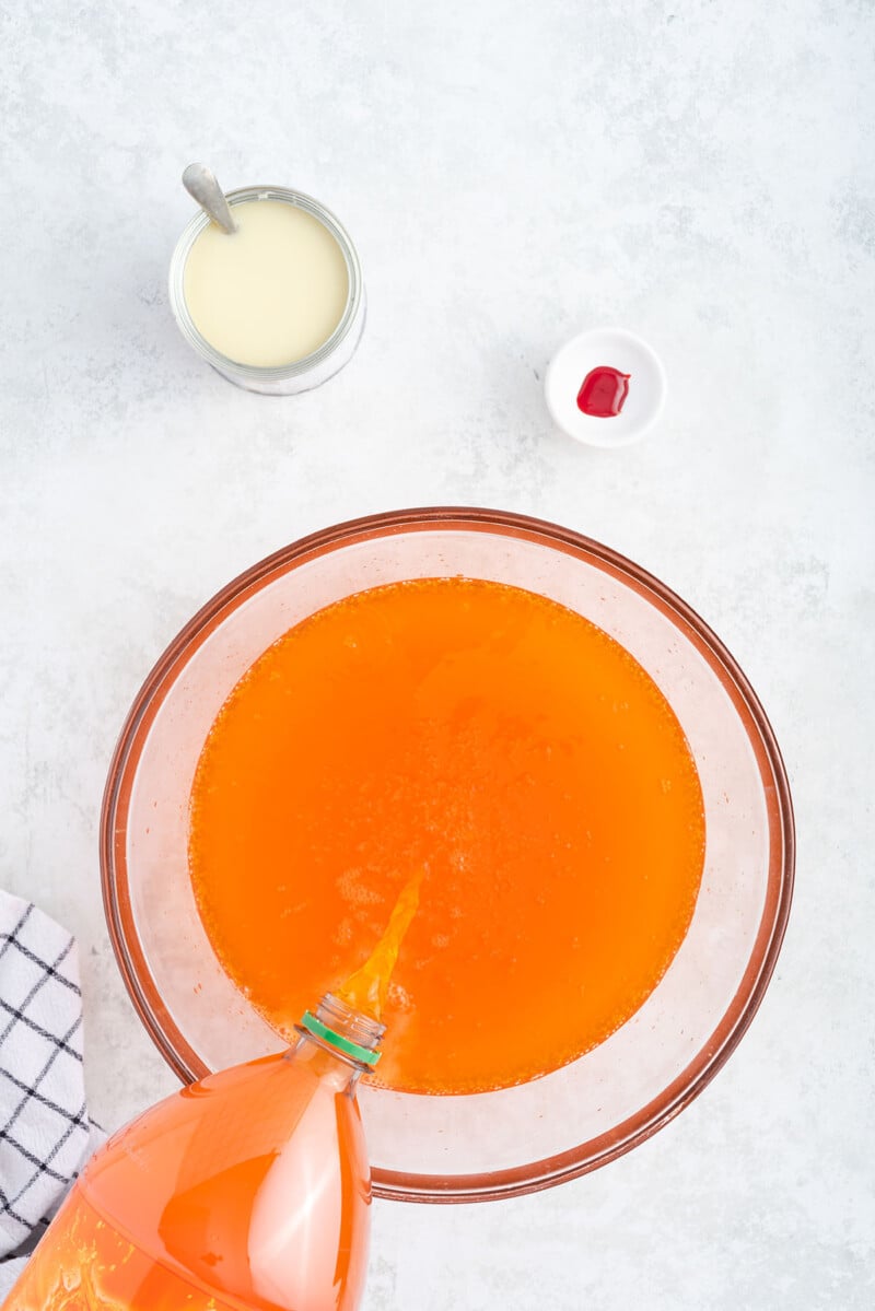pour orange soda into a bowl