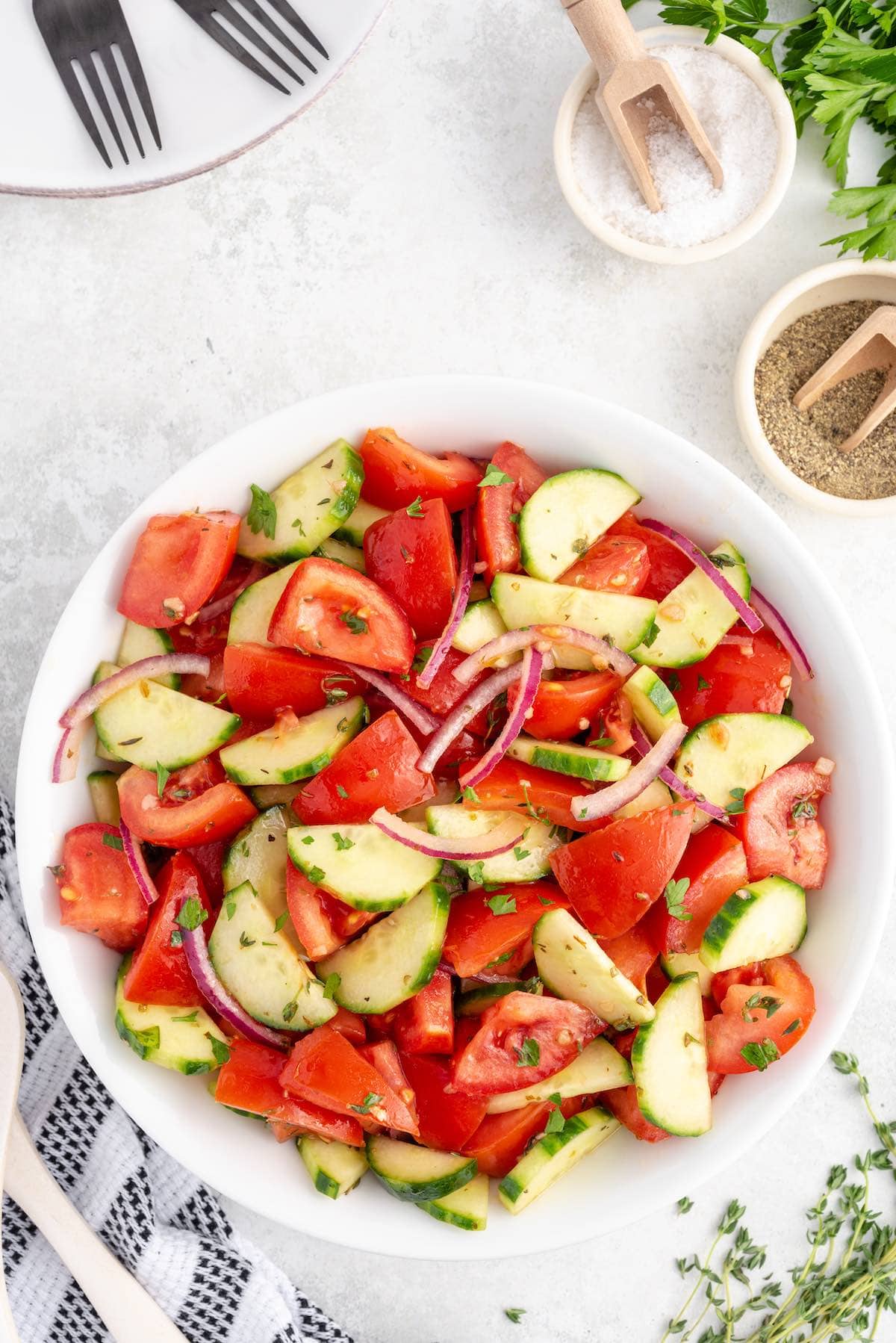 tomato cucumber salad in a white bowl