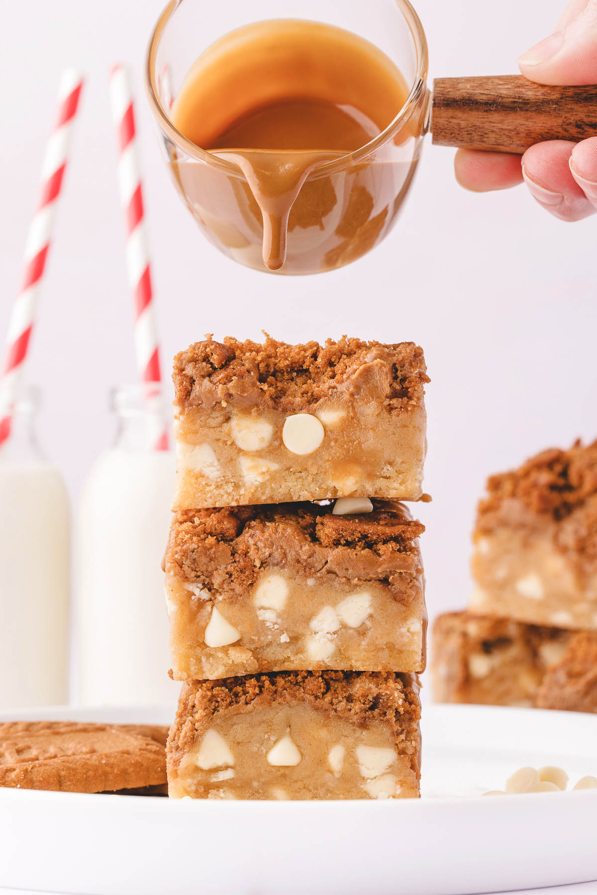 pouring caramel sauce into biscoff blondies