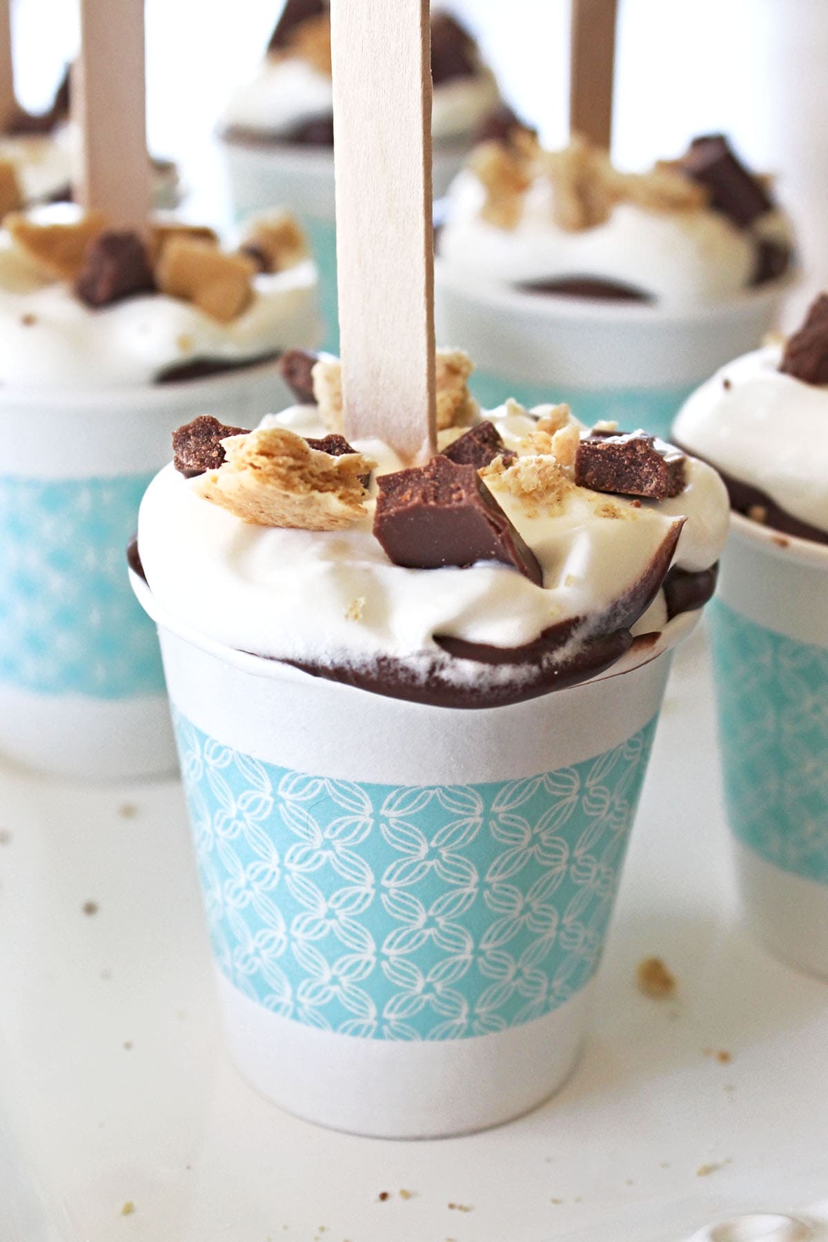 Layered S'mores Pops in a blue cup