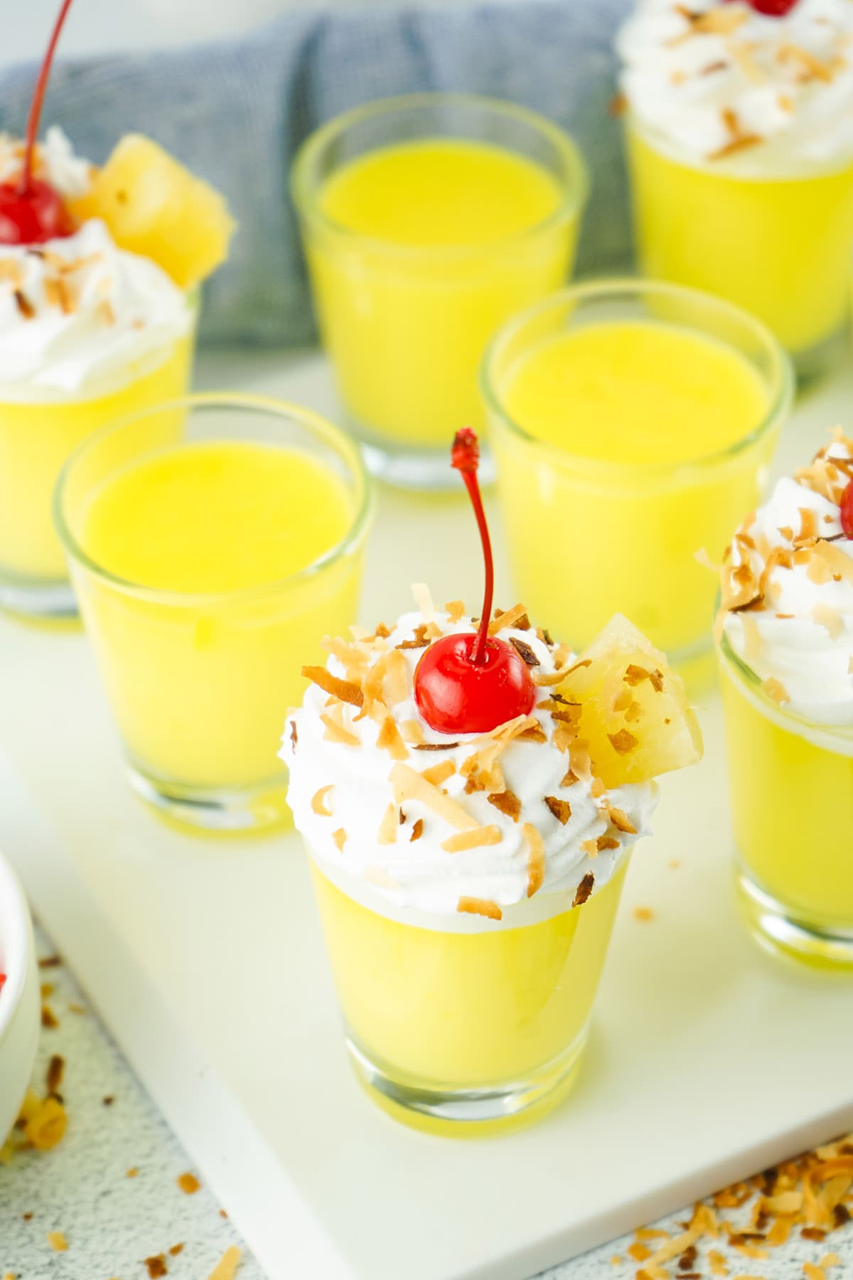 pina colada pudding shot with pineapple topping
