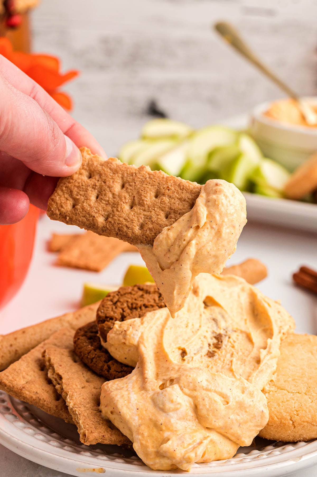 dipping crackers into the pumpkin pie dip