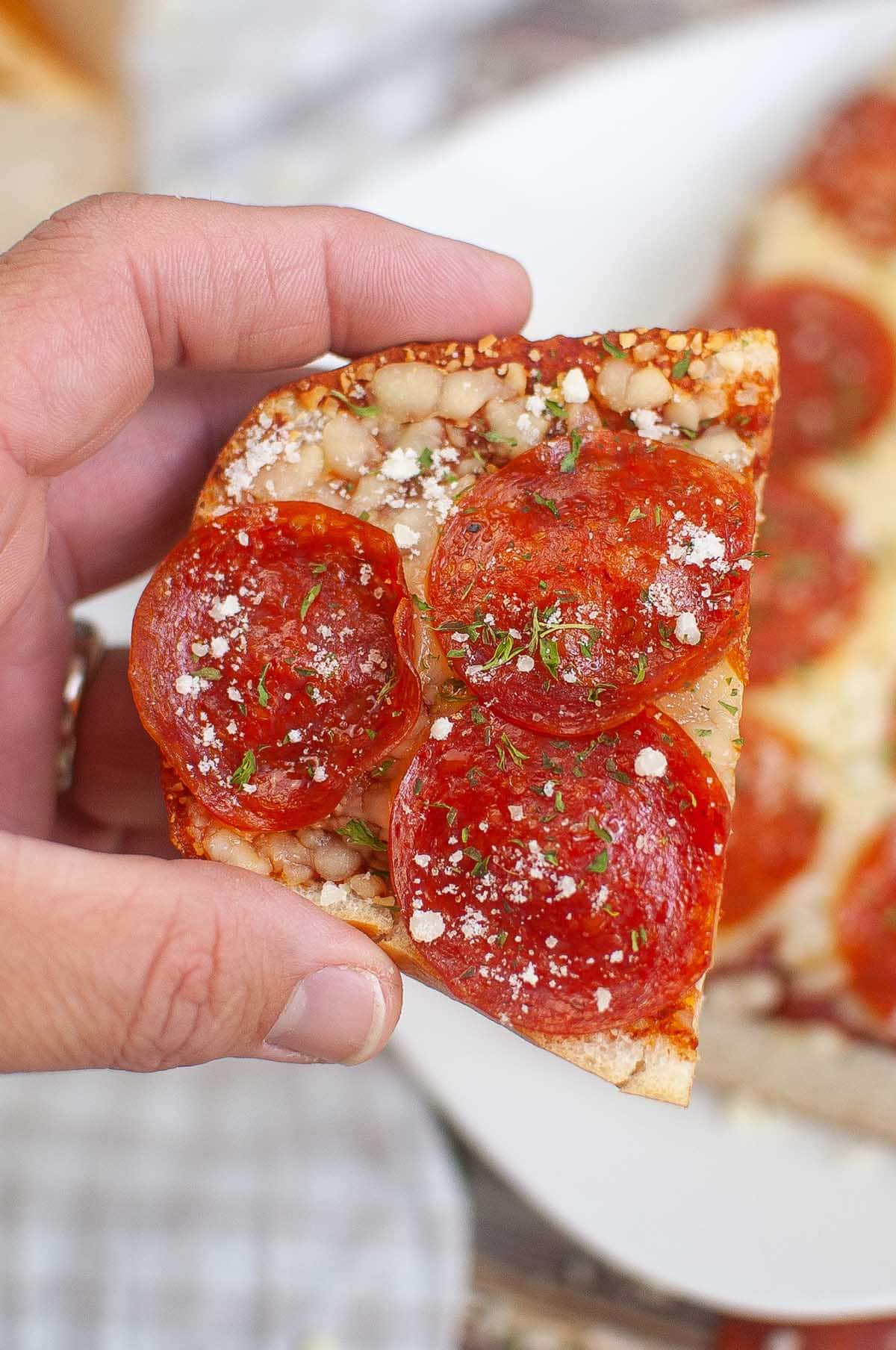 hand holding Air Fryer French Bread Pizza