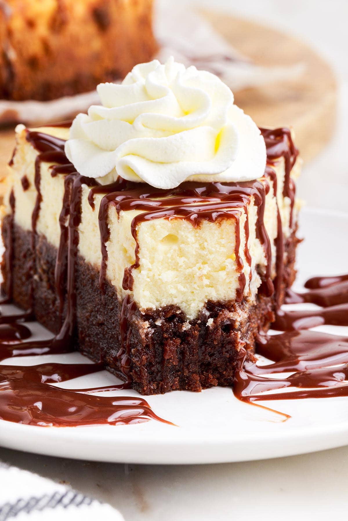 brownie bottom cheesecake with whipped cream image