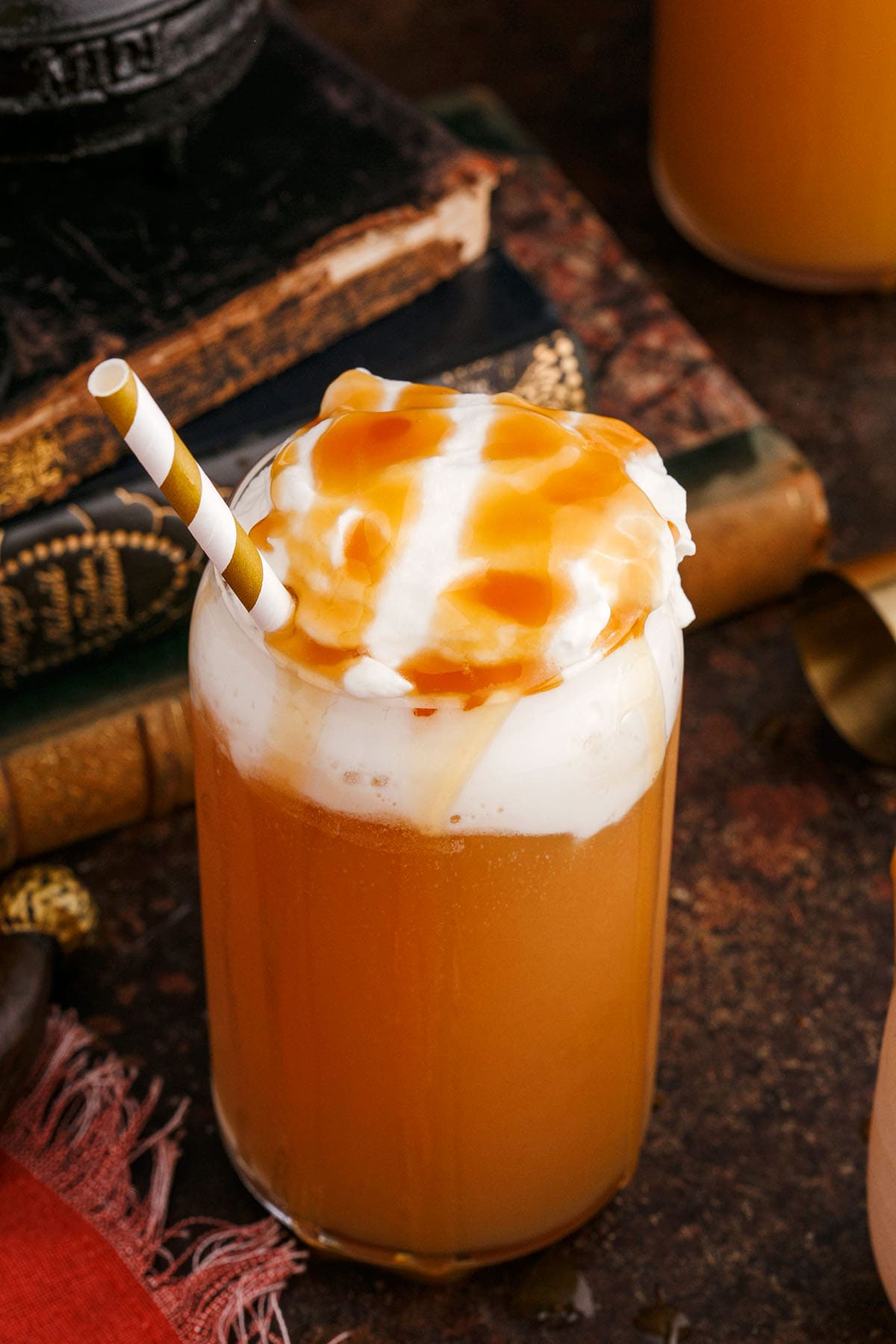 a glass of Alcoholic Butterbeer with whipped cream.