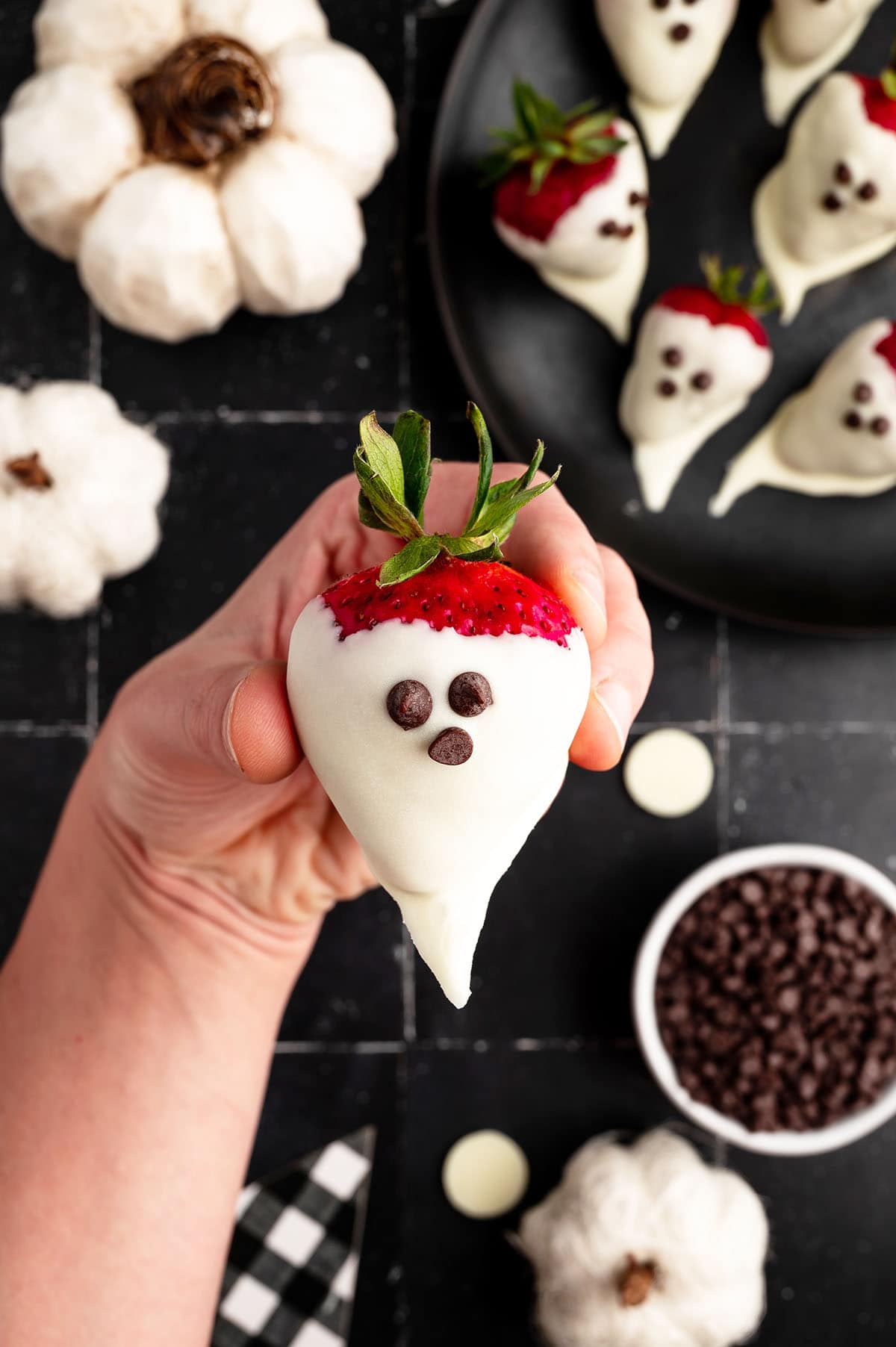 hand holding Spooky Ghost Strawberries