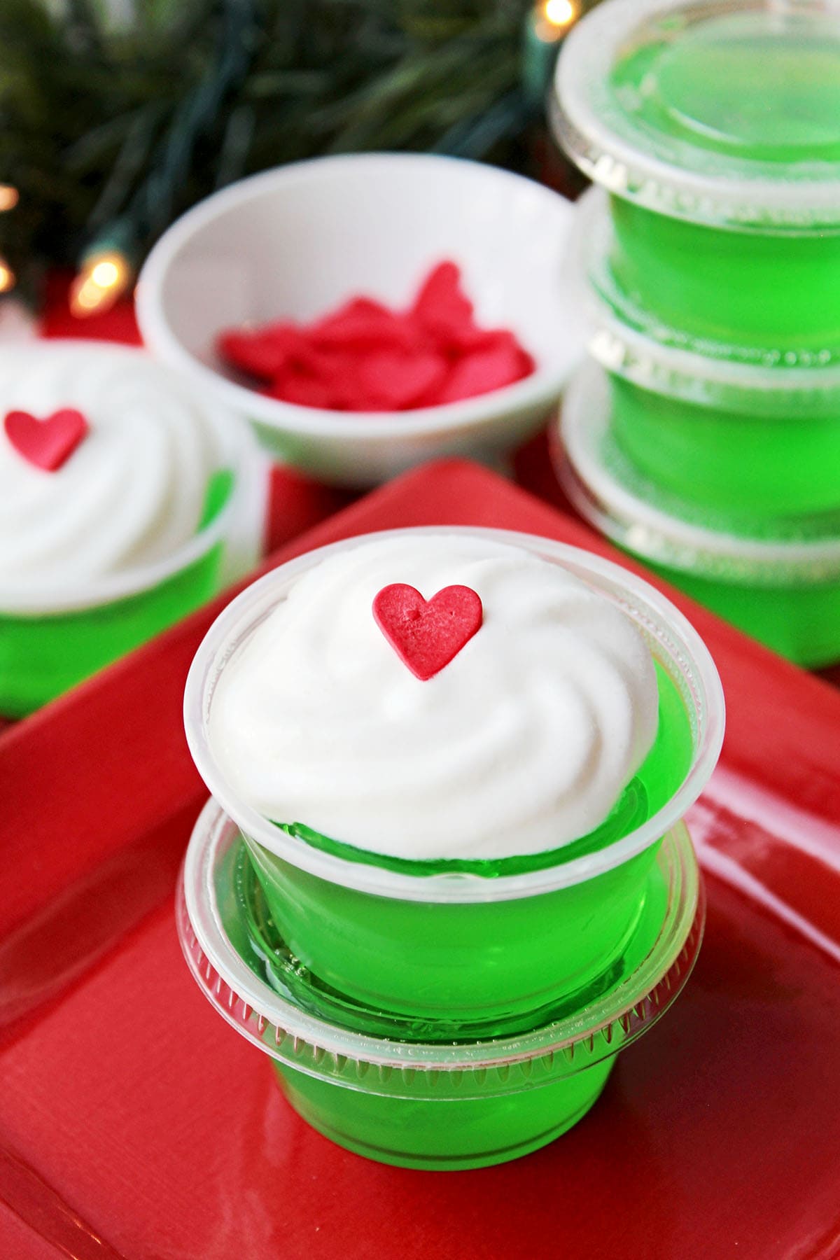 grinch jello shots with whipped cream and heart on top