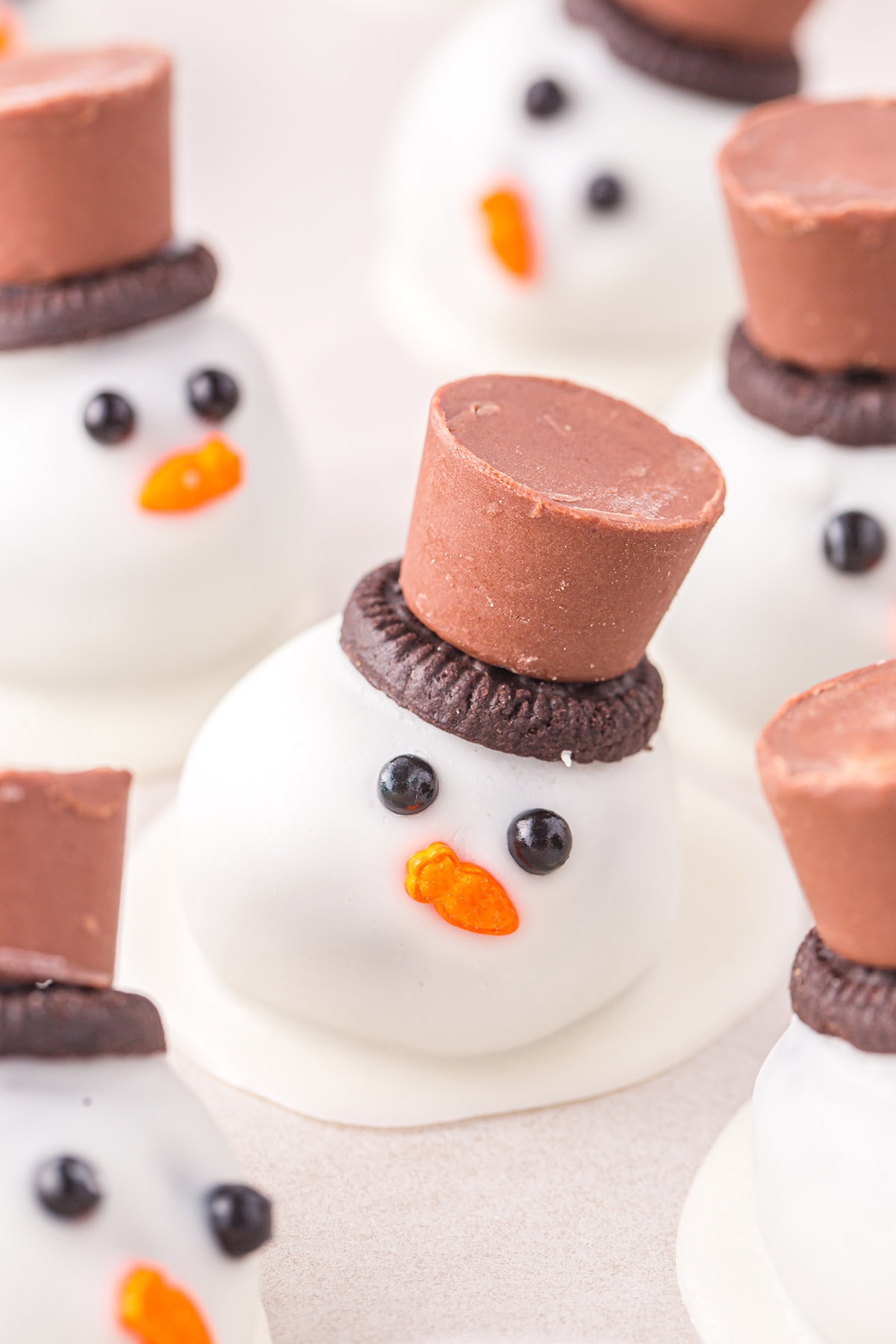 melted snowman oreo balls with rolo candy on top