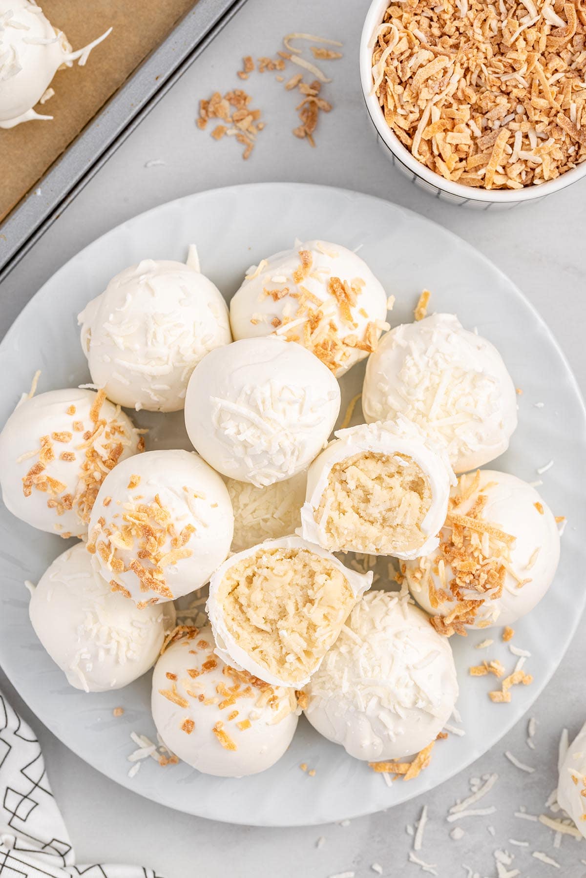 Coconut Cheesecake Bites with coconut sprinkles on plate