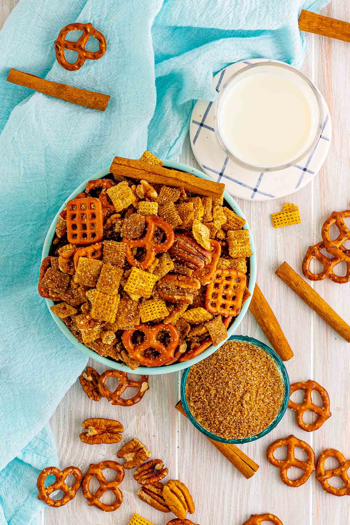 top shot of cinnamon sugar chex mix on the table with milk