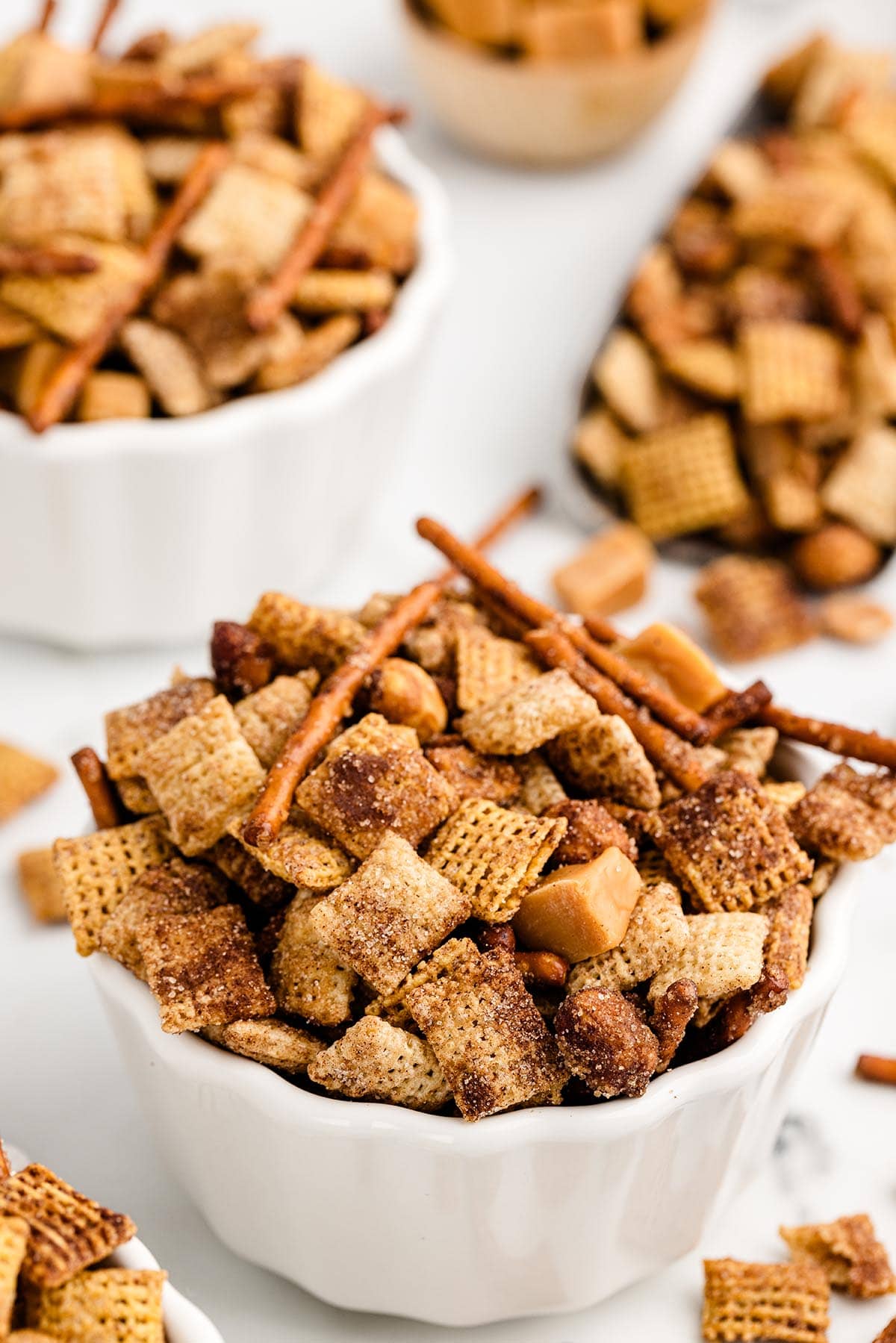 a couple of bowls with churro chex mix. 
