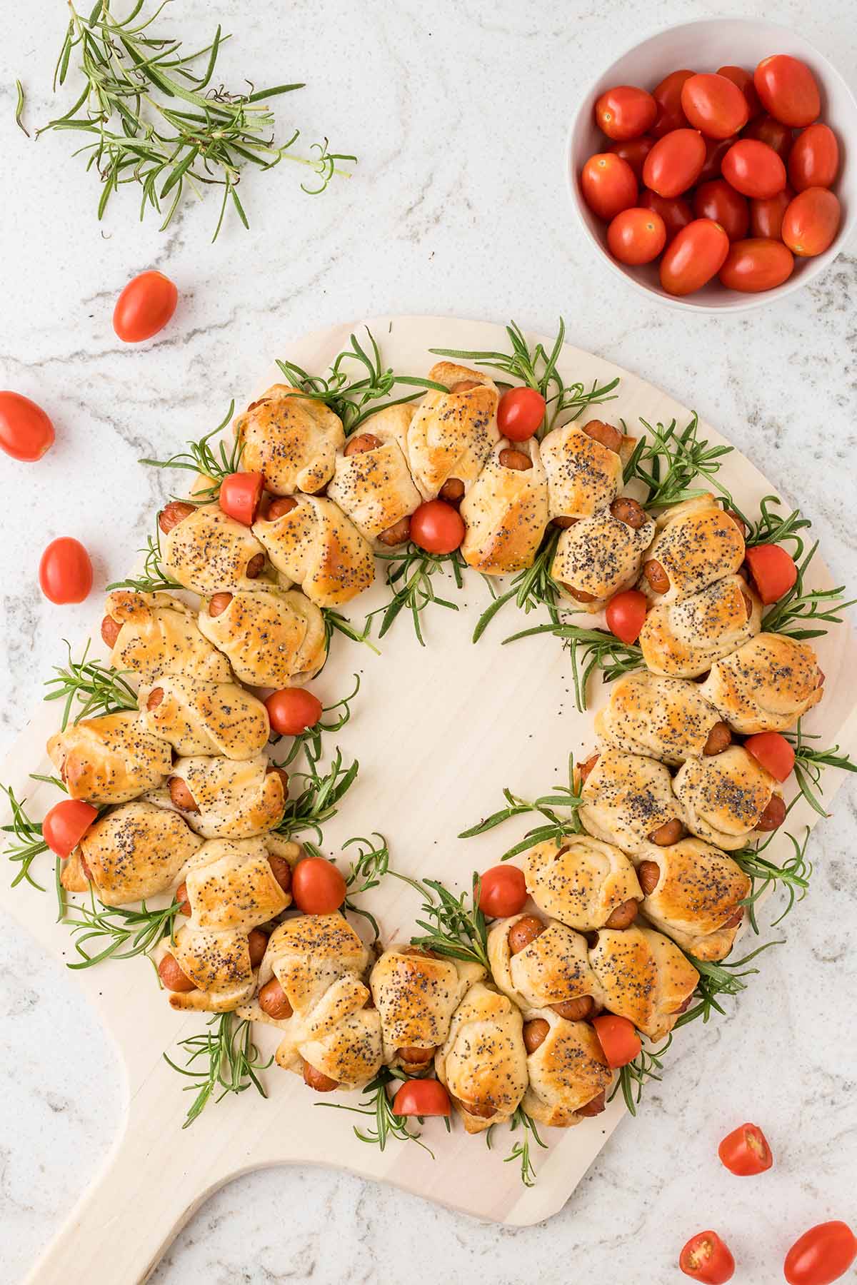 top shot of Pigs in a Blanket Wreath with tomatoes