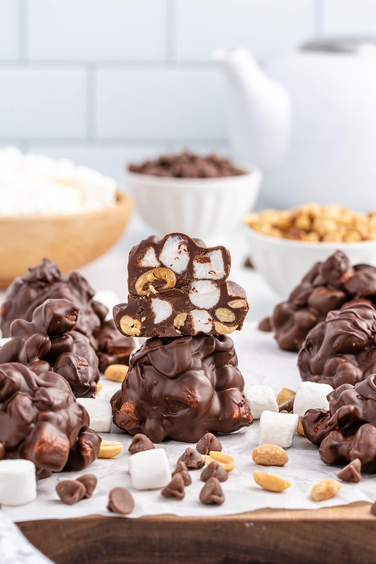 Stacked rocky road candy showing marshmallows, peanuts, and chocolate.