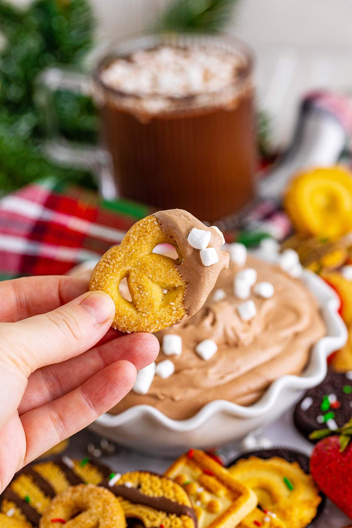 hand holding pretzel with Hot Chocolate Dip