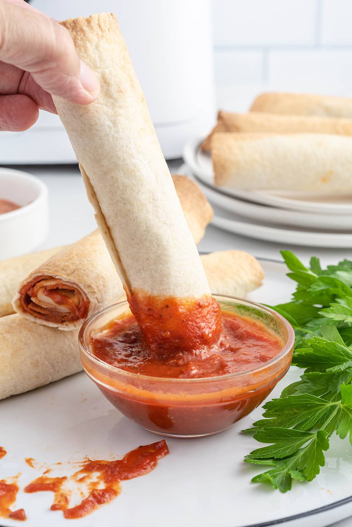 Air Fryer Pizza Rolls dipped in sauce