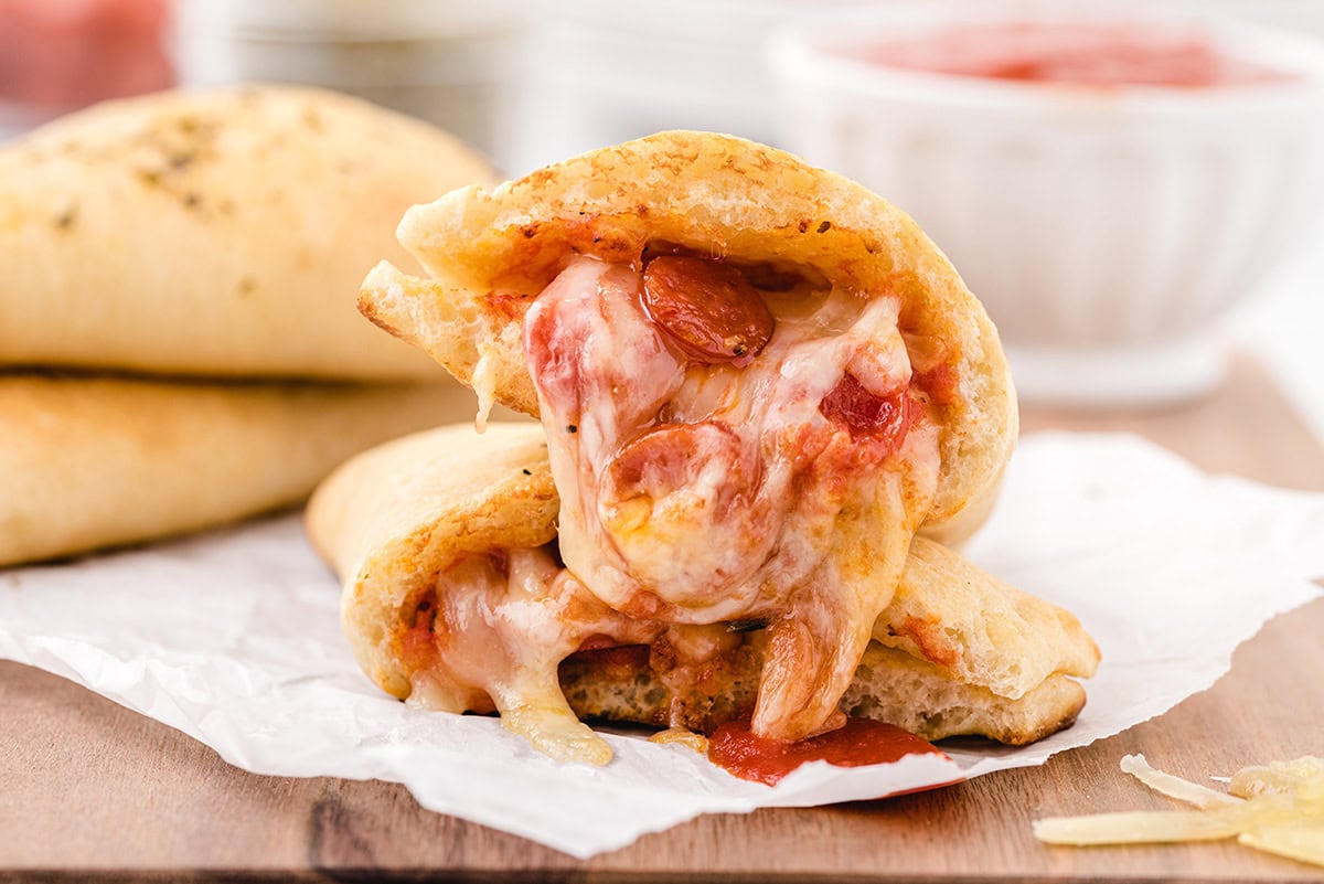 pizza pocket with cheese and pepperoni inside. 