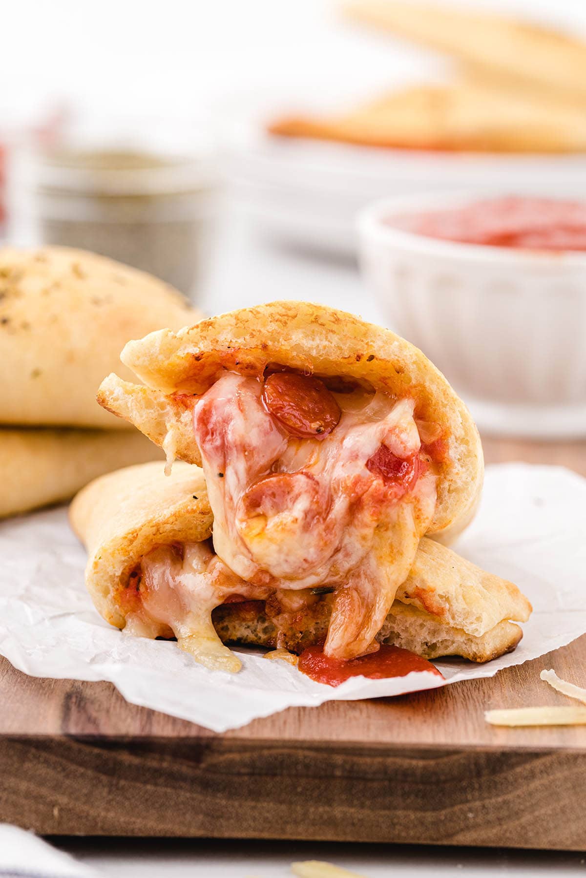 pizza pocket split in half on top of wooden board. 