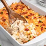 crack chicken casserole scooped out using wooden spoon.