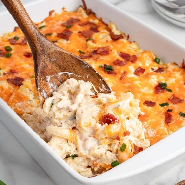crack chicken casserole scooped out using wooden spoon.
