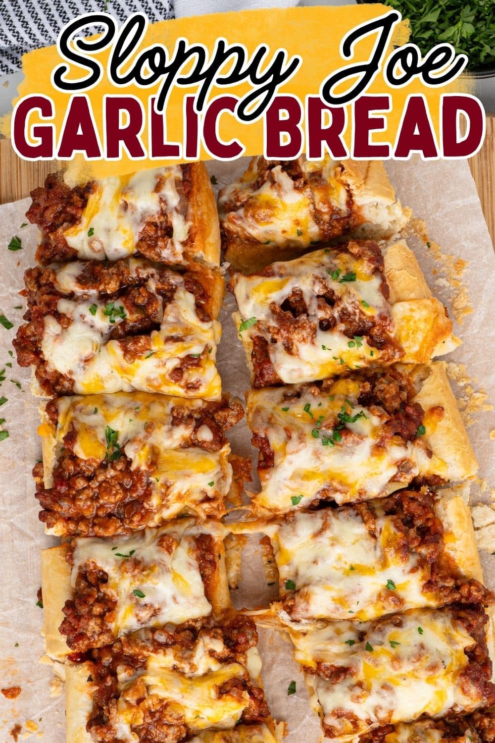 Overhead view of sliced sloppy joe garlic bread topped with melted cheese and ground meat.