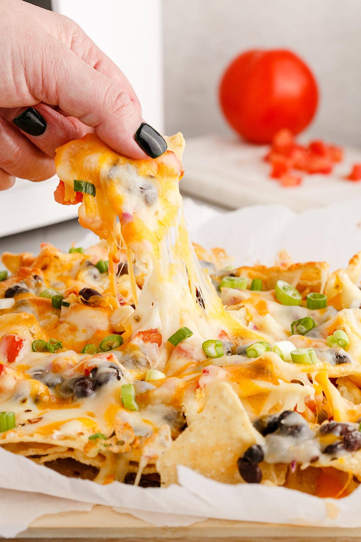 eating Air Fryer Nachos with hand