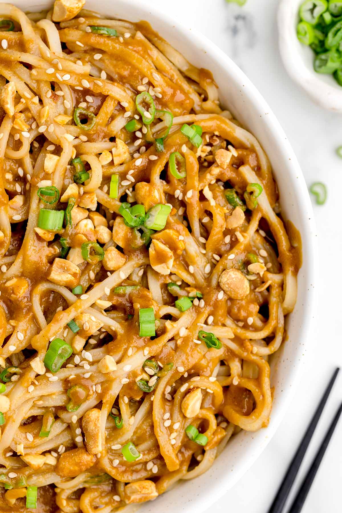 Peanut Noodles garnished with sesame seeds and scallions