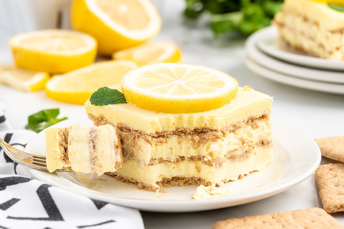 eating Lemon Eclair Cake on a plate
