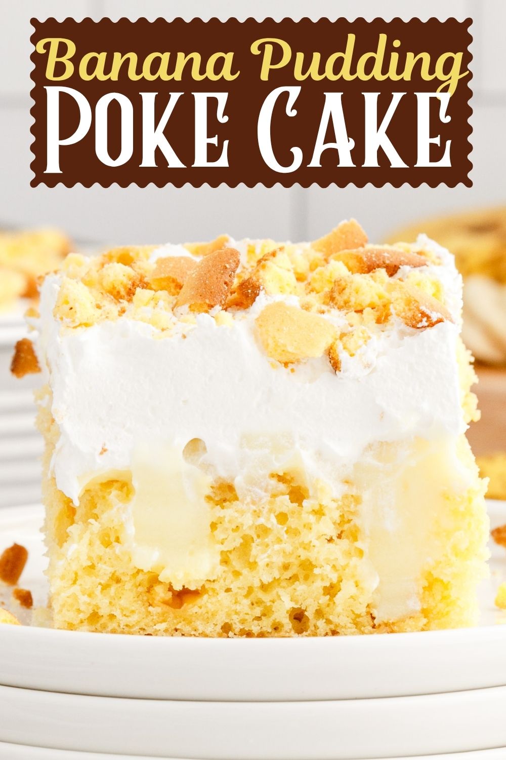 A slice of Banana Pudding Poke Cake on a white plate.