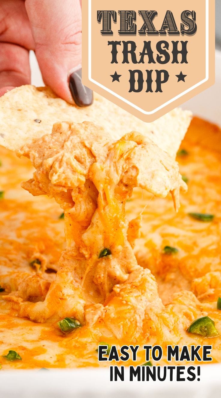 hand holding a chip digging into the creamy texas trash dip