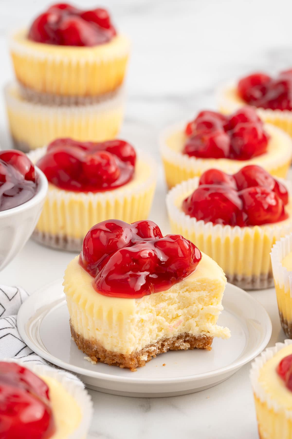 bitten mini cheesecake served on a plate. 