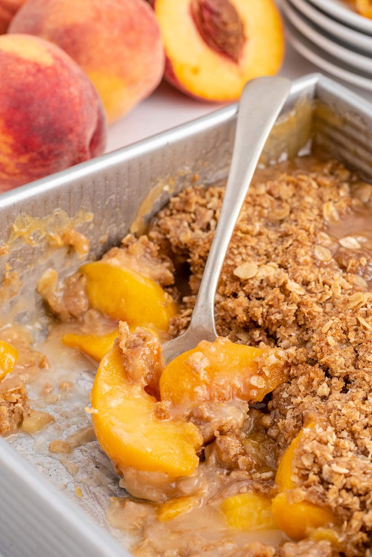eating Peach Crisp with spoon