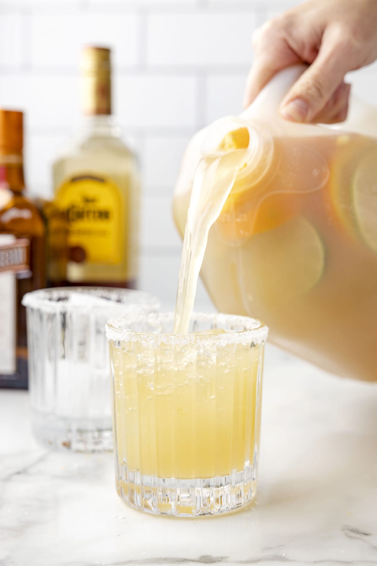 pouring margarita to a glass