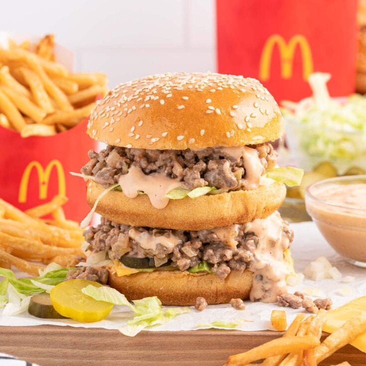 Big Mac sloppy joe with lettuce, pickles, sauce, and fries in the background.