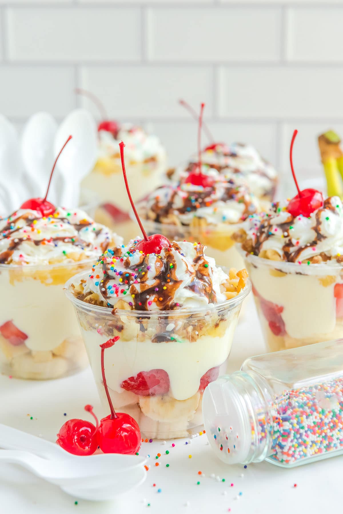 Banana Split Pudding Cups with cherries on top
