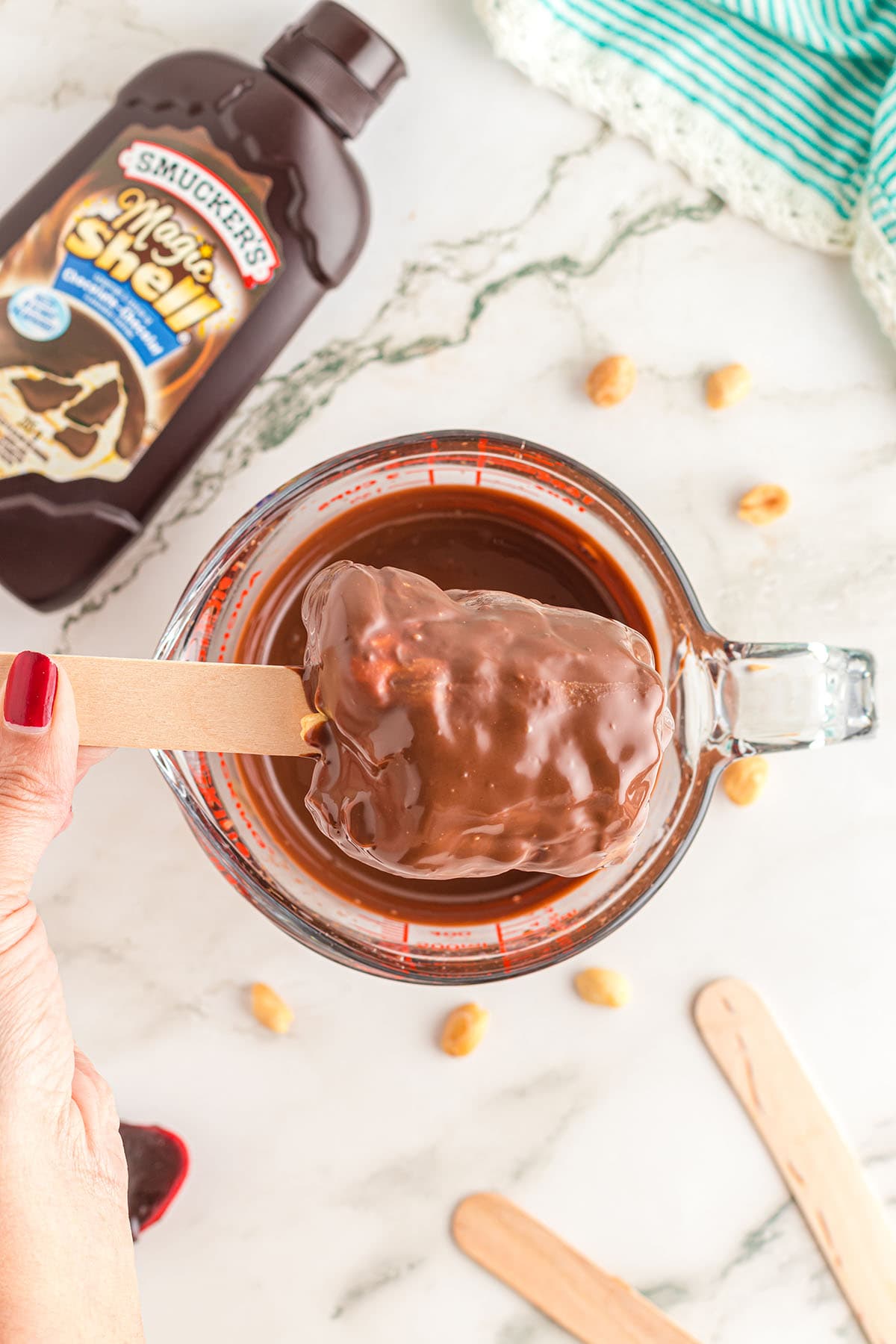 dip DQ Copycat Buster Bars into melted chocolate