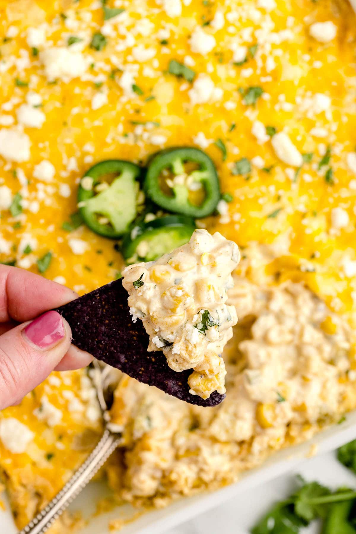 eating Mexican Street Corn Dip with chips