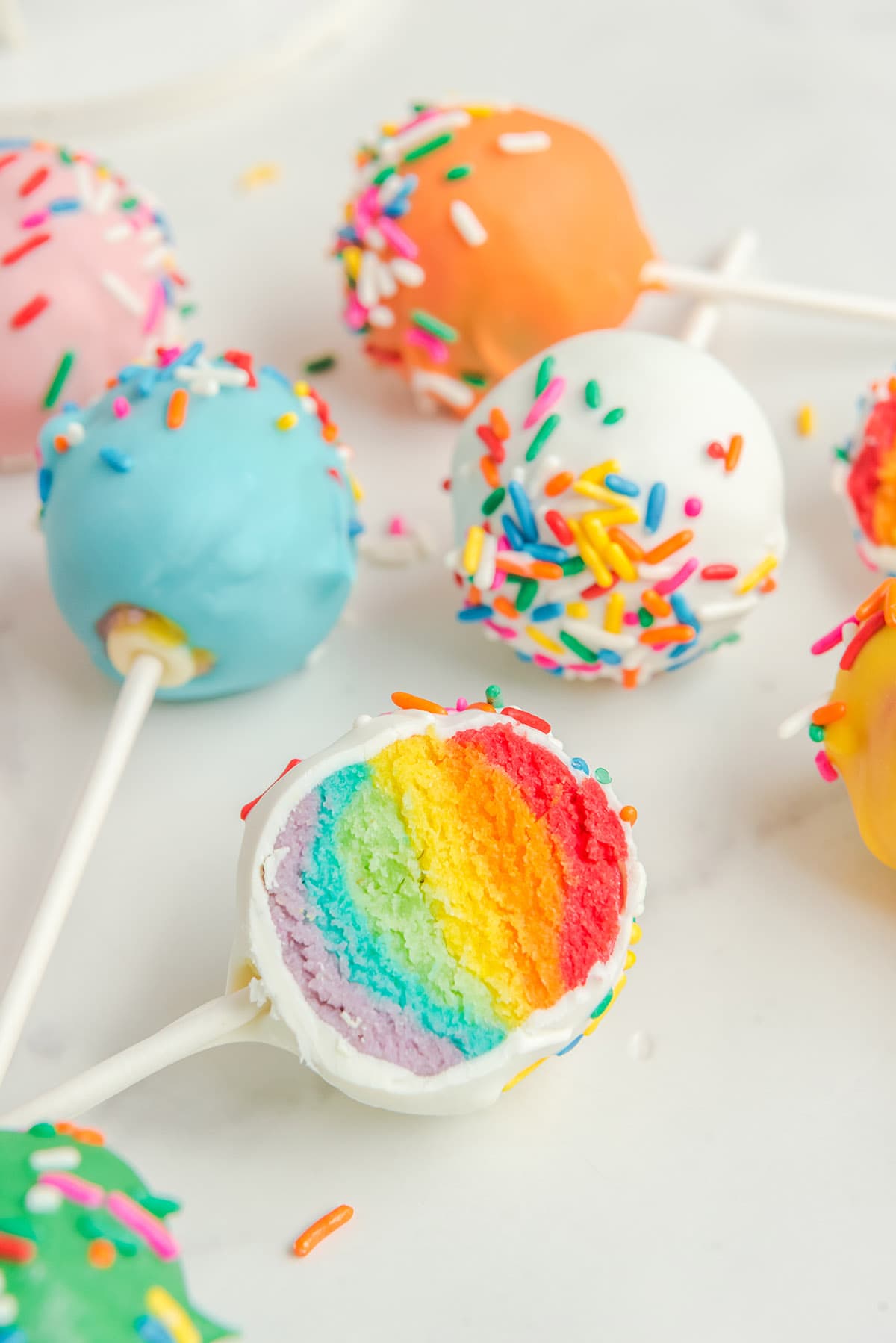 Rainbow Cake Pops on a white table