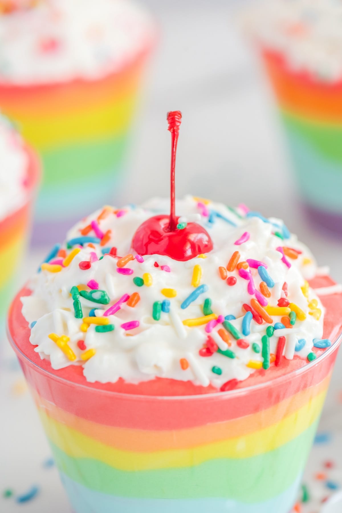 Rainbow Pudding Cups with cherry on top