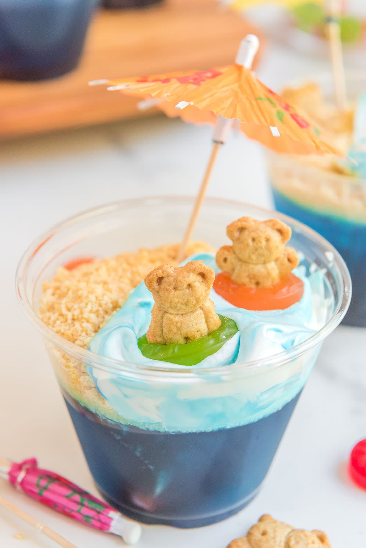 Beach Party Jello Cups decorated with teddy biscuits and umbrella