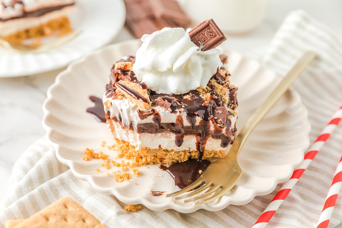 S'mores Lush Cake with chocolate syrup on top