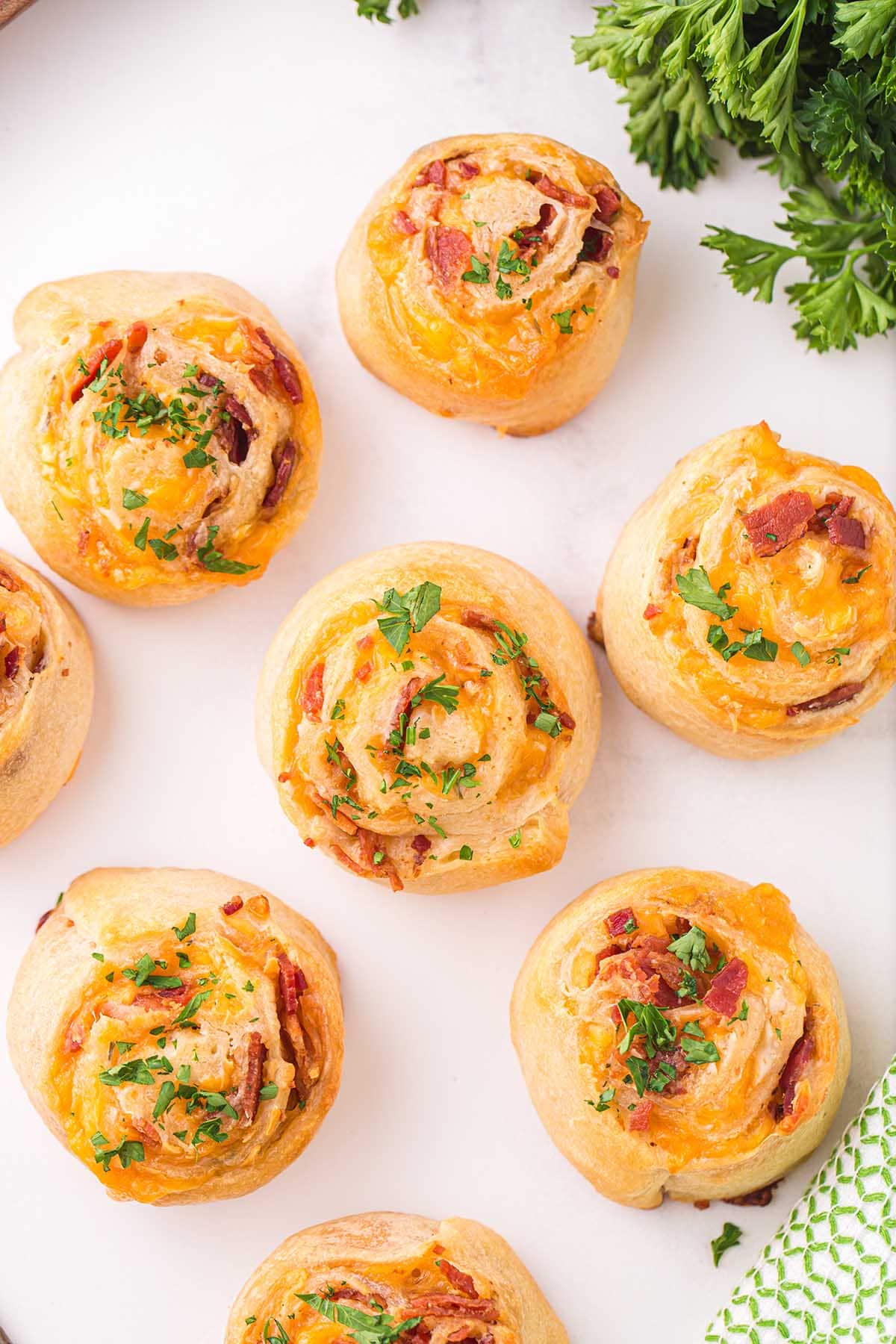 a couple of Cheddar Bacon Pinwheels on a white table