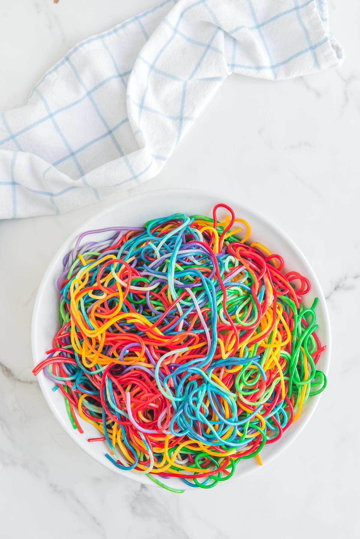 Rainbow Spaghetti on a white table