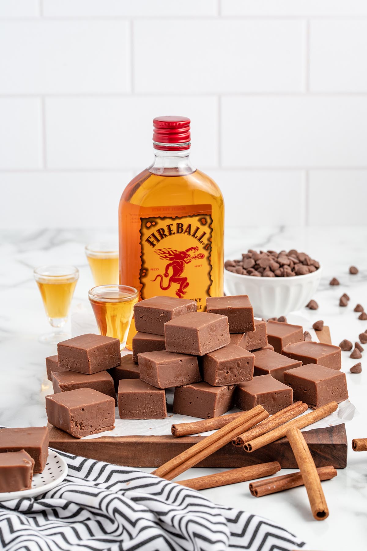 square pieces of fireball fudge with fireball whiskey bottle in the background