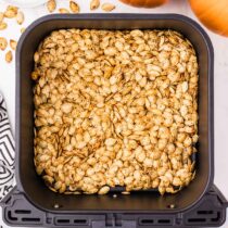 air fryer pumpkin seeds inside the air fryer.