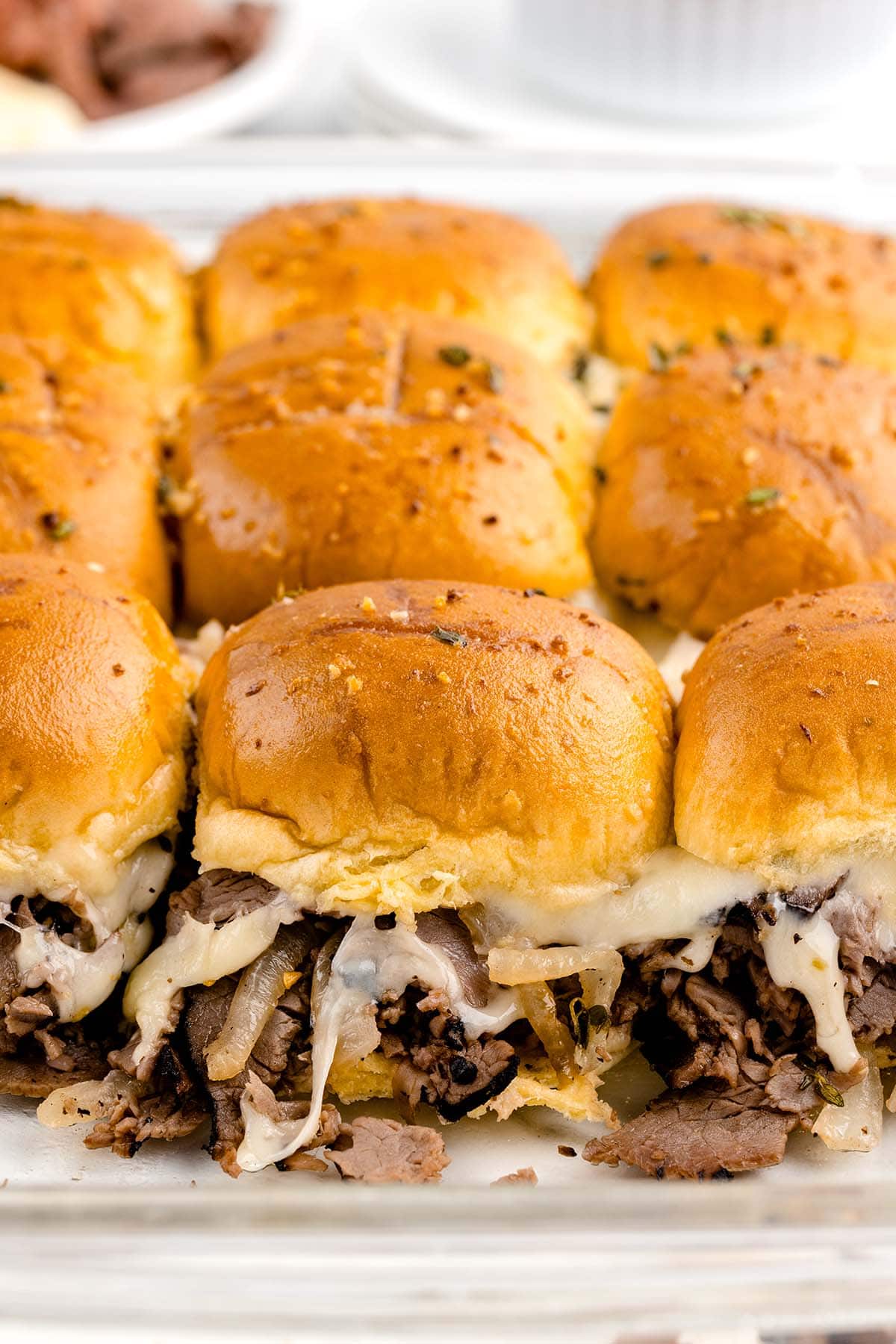 french dip sliders in a casserole dish
