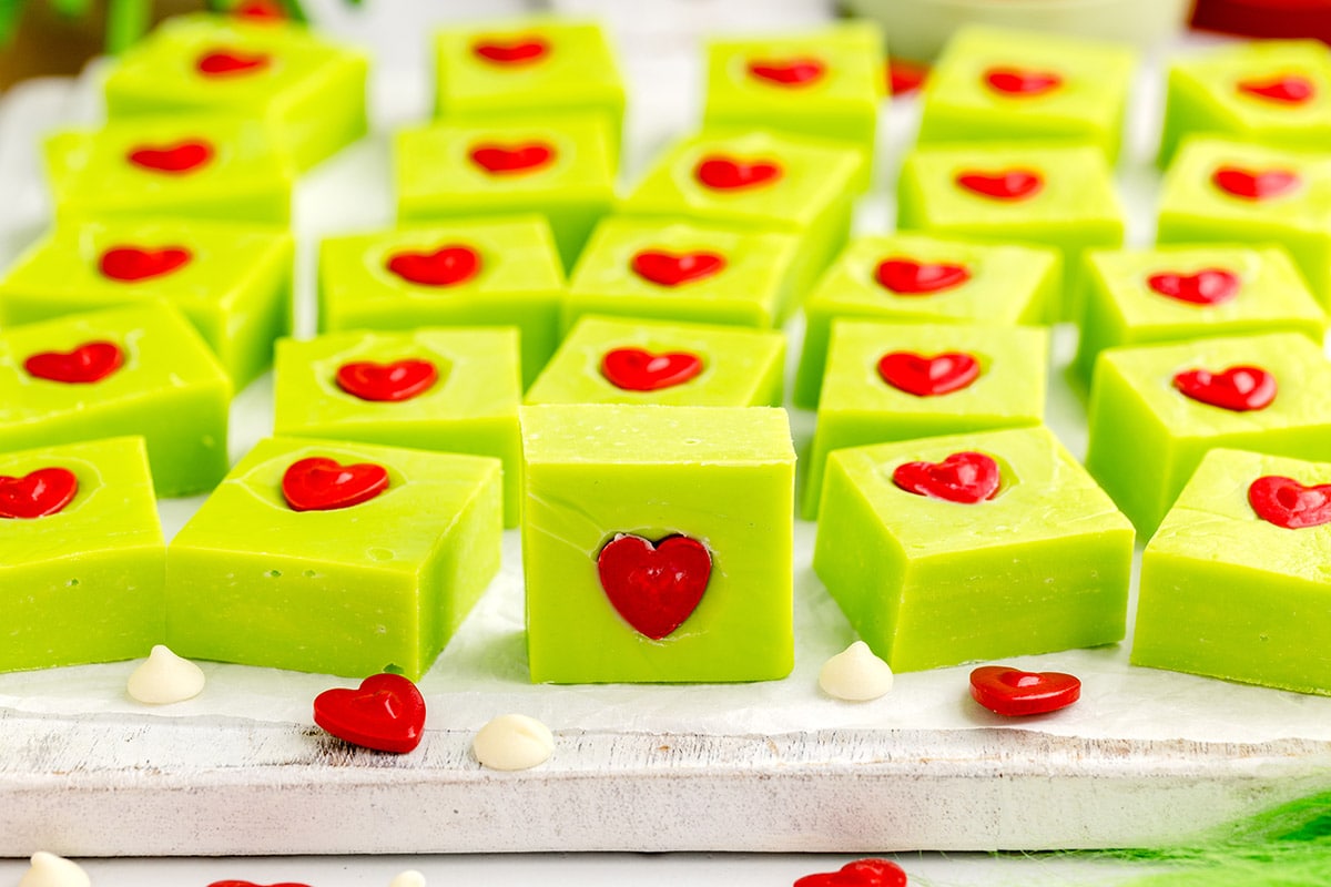 a couple of square grinch fudge on top of parchment paper.