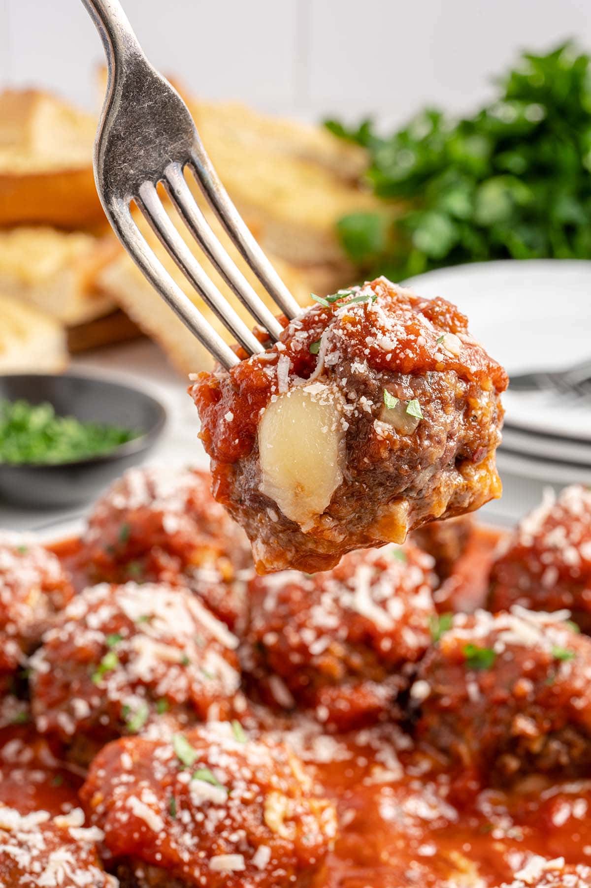 eating Cheese Stuffed Meatballs with fork