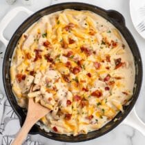Crack Chicken Penne on a skillet with wooden spoon.